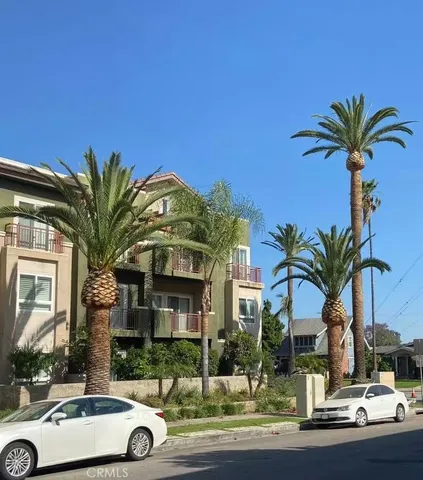 a front view of multiple houses with yard