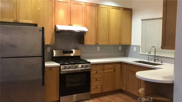 a kitchen with a sink stove and cabinets