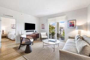 250 Northeast 3rd Avenue, Unit 1510 Delray Beach, FL 33444 - Photo 12 of 50 a living room with furniture and a flat screen tv