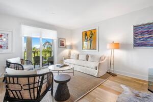 250 Northeast 3rd Avenue, Unit 1510 Delray Beach, FL 33444 - Photo 13 of 50 a living room with furniture a lamp and a potted plant