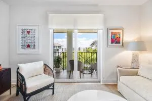 a kitchen with stainless steel appliances granite countertop a refrigerator a sink a stove a oven a dining table and chairs with wooden floor