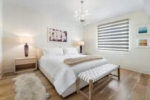 a bedroom with a bed and a table with potted plants