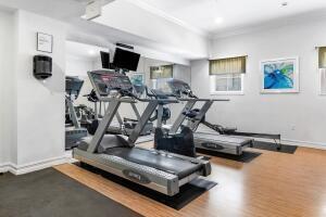 250 Northeast 3rd Avenue, Unit 1510 Delray Beach, FL 33444 - Photo 31 of 50 a living room with furniture gym equipment and a flat screen tv