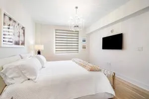 a bedroom with a bed tv and a window