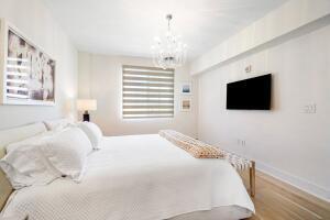 250 Northeast 3rd Avenue, Unit 1510 Delray Beach, FL 33444 - Photo 38 of 50 a bedroom with a bed tv and a window