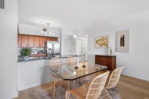 250 Northeast 3rd Avenue, Unit 1510 Delray Beach, FL 33444 - Photo 43 of 50 a dining room with furniture and a kitchen view