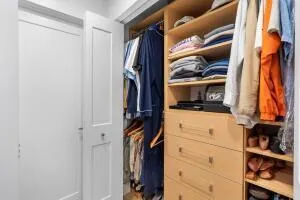 a view of walk in closet with clothes and shoes