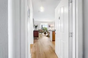 a view of living room with furniture and wooden floor