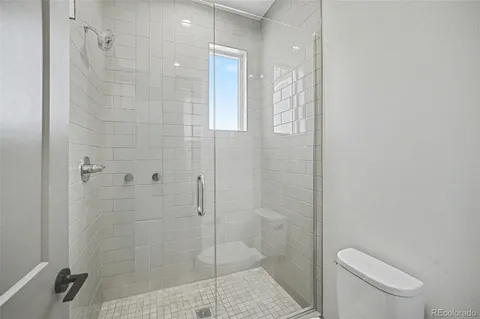 a bathroom with a shower and toilet