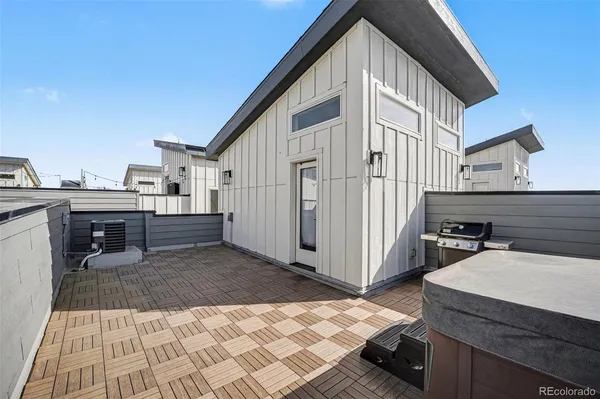 a view of a house with backyard and sitting area