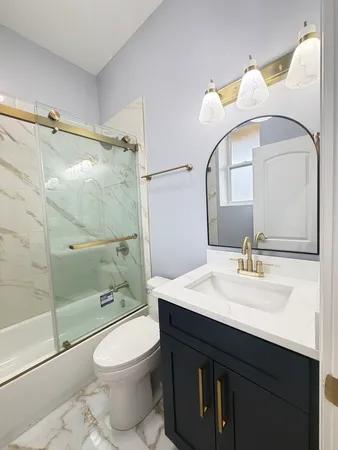 a bathroom with a sink vanity mirror and toilet