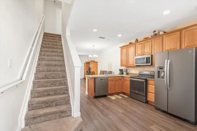 a kitchen with cabinets and wooden floor