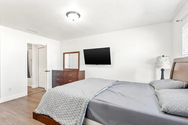 a bedroom with a bed and a flat screen tv