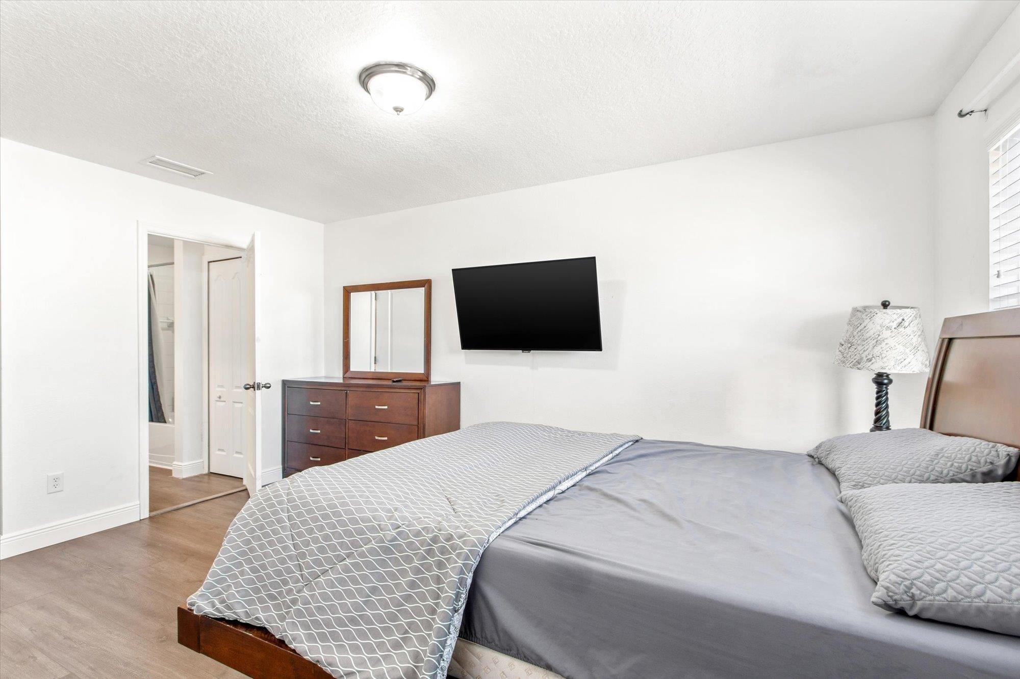 653 Drake Bay Terrace St. Augustine, FL 32084 - Photo 13 of 32 a bedroom with a bed and a flat screen tv