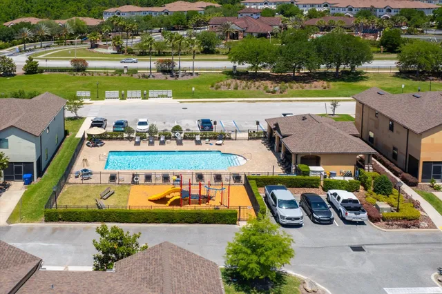 an aerial view of a house with yard swimming pool and outdoor seating