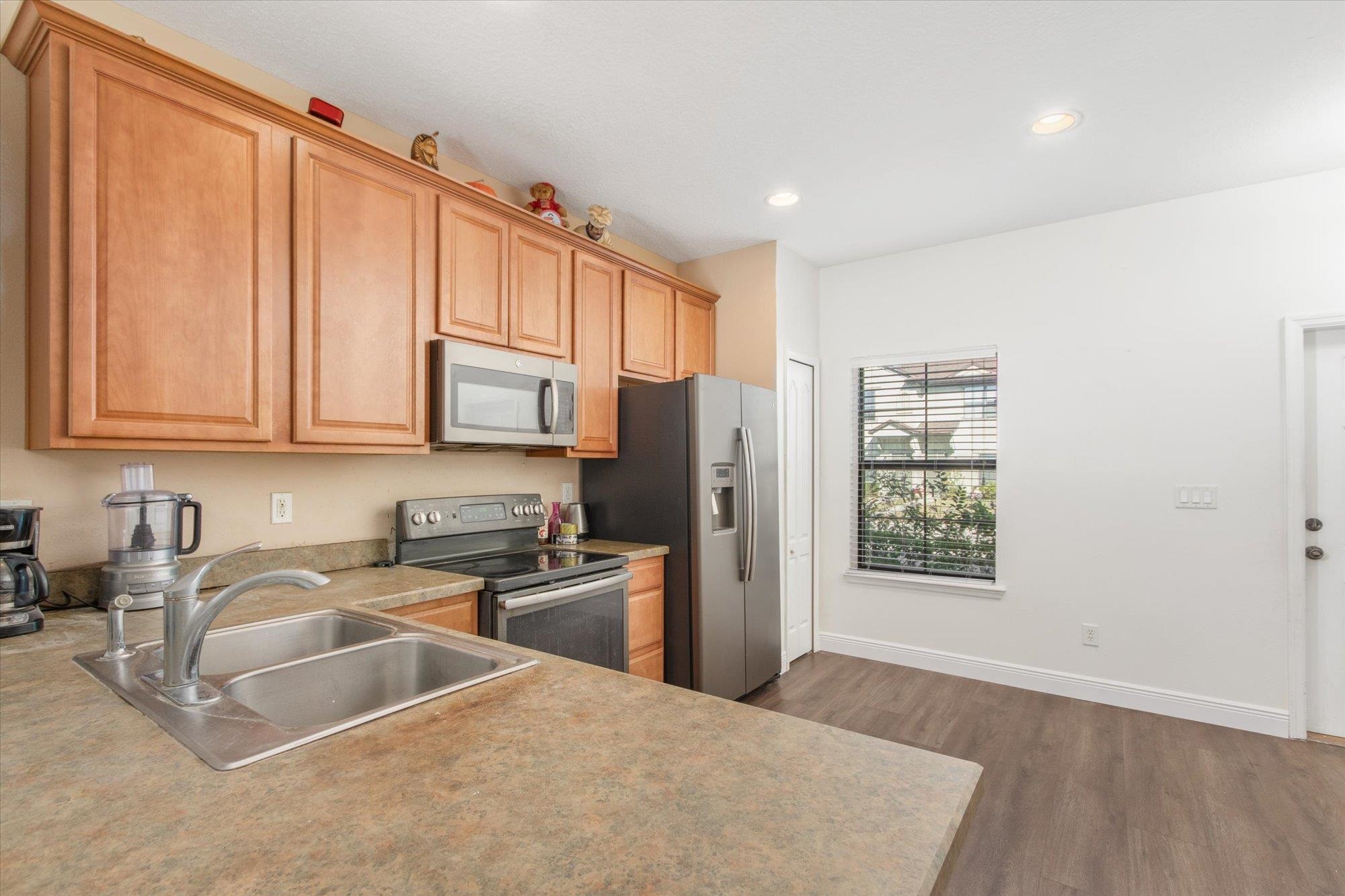 653 Drake Bay Terrace St. Augustine, FL 32084 - Photo 4 of 32 a kitchen with stainless steel appliances granite countertop a refrigerator sink and cabinets