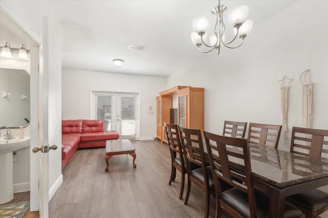 a view of a dining room with furniture wooden floor and chandelier