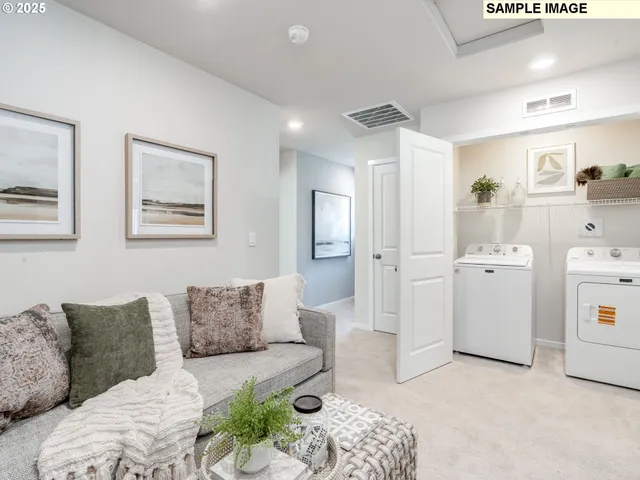a living room with furniture and white walls