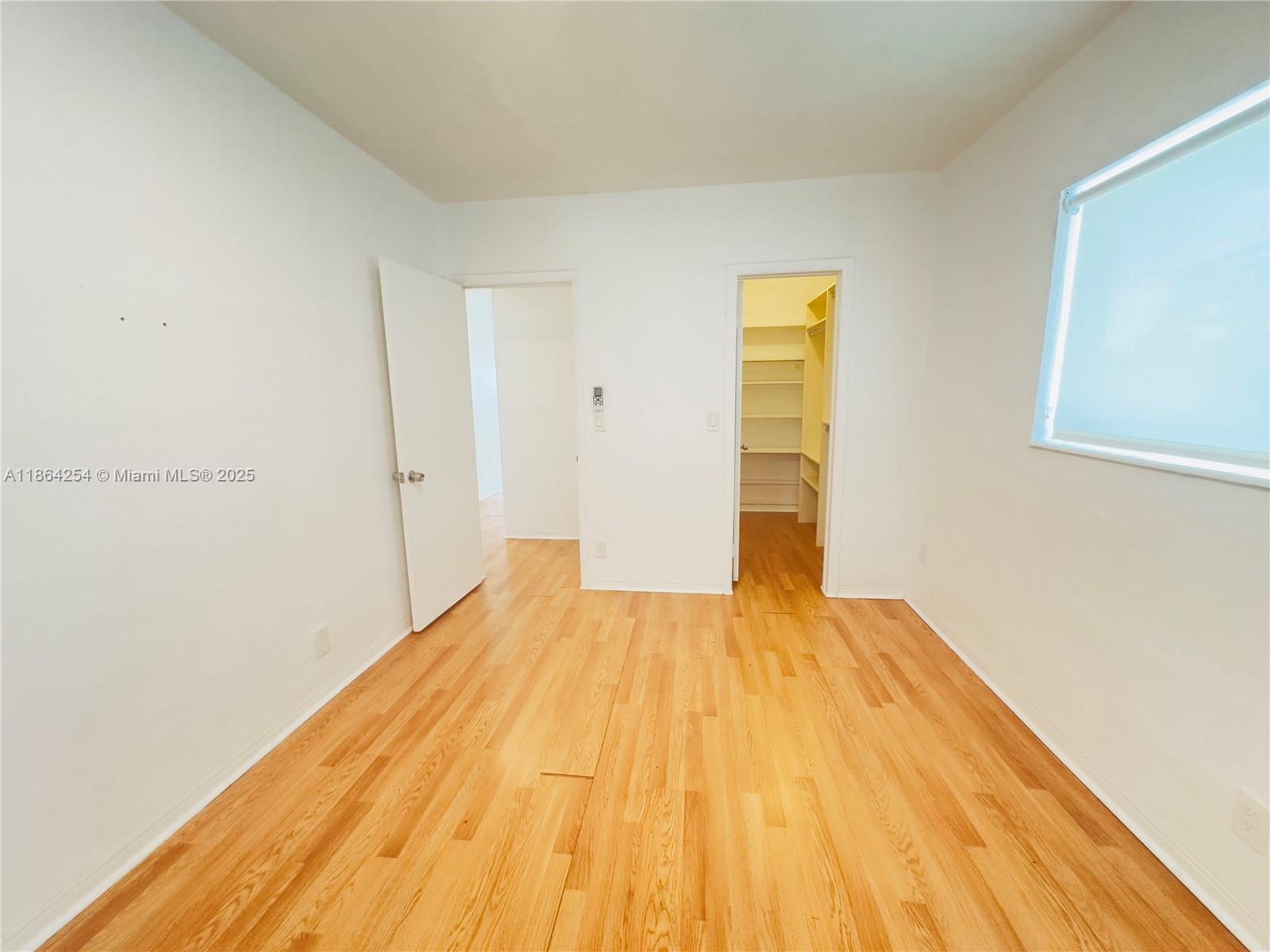 455 Golden Isles Drive, Unit 210 Hallandale Beach, FL 33009 - Photo 14 of 27 a view of empty room with wooden floor