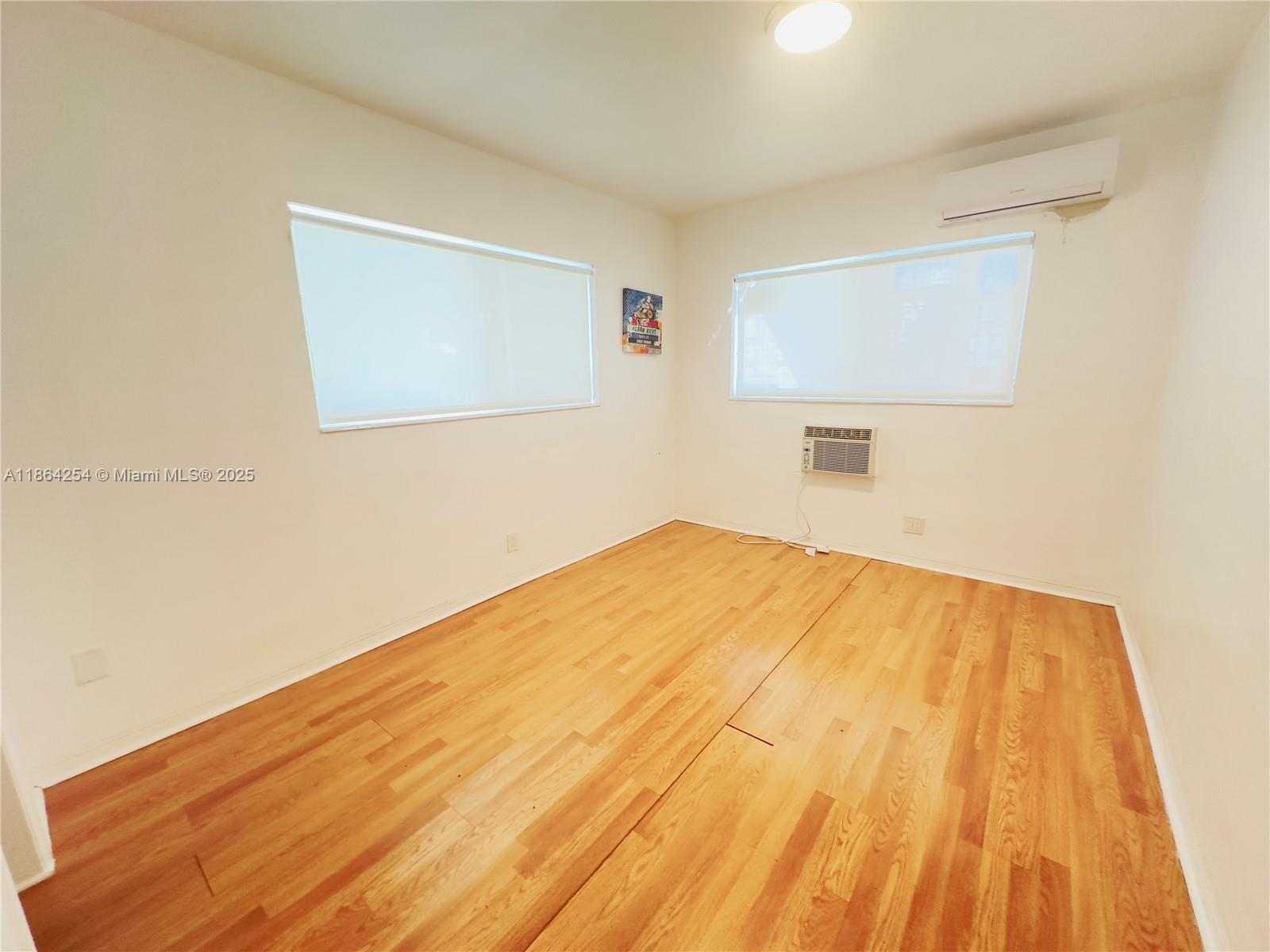 455 Golden Isles Drive, Unit 210 Hallandale Beach, FL 33009 - Photo 15 of 27 a bedroom with a bed and a window