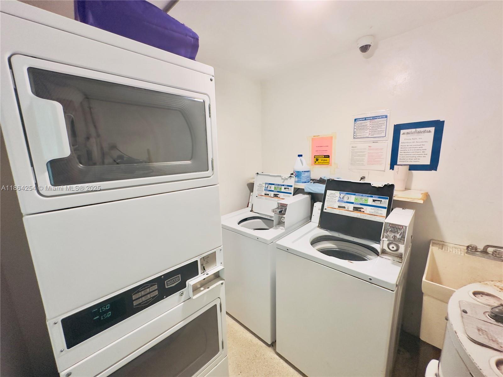 455 Golden Isles Drive, Unit 210 Hallandale Beach, FL 33009 - Photo 17 of 27 a utility room with dryer and washer