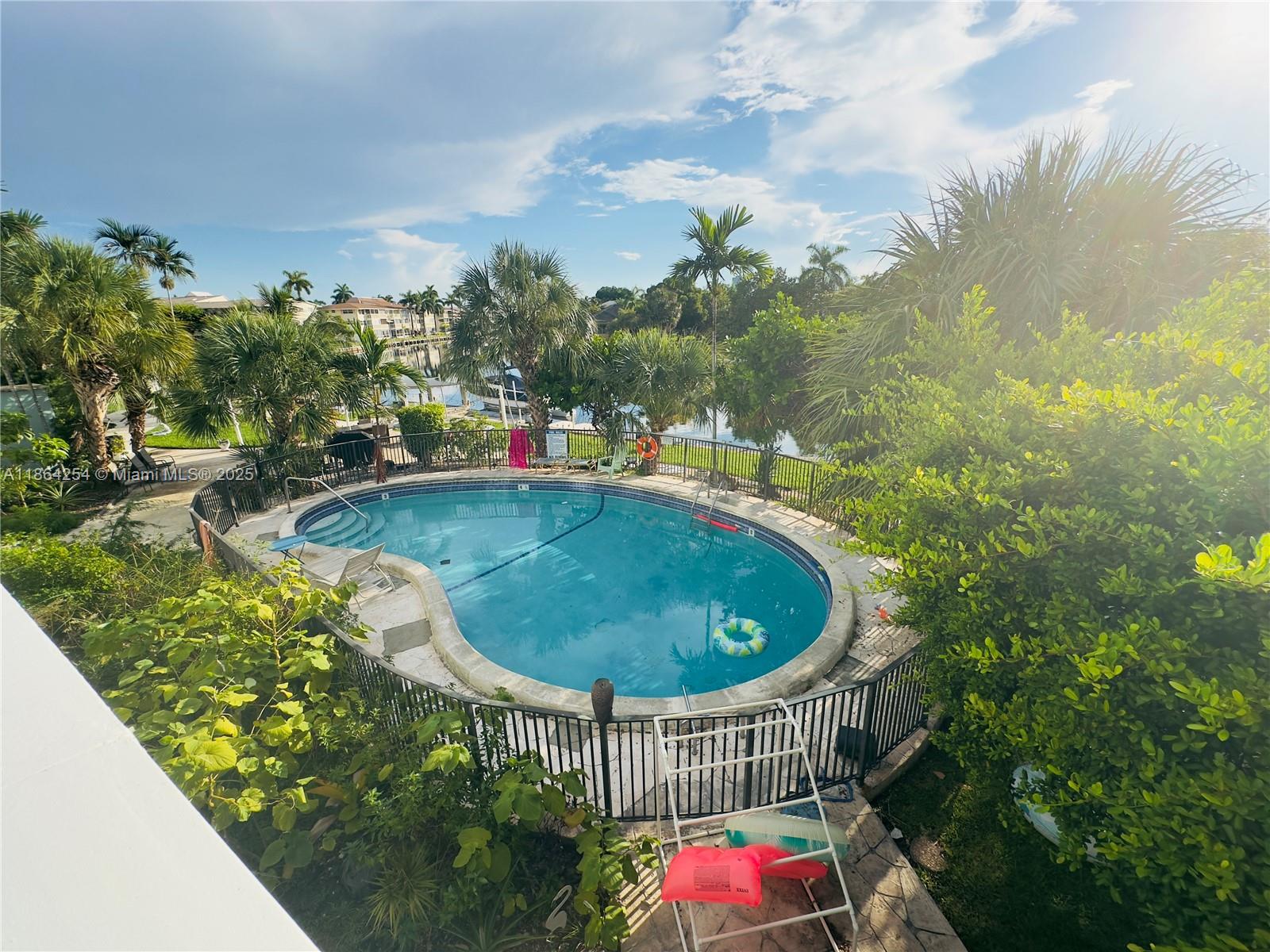 455 Golden Isles Drive, Unit 210 Hallandale Beach, FL 33009 - Photo 20 of 27 a view of a balcony with swimming pool and outdoor seating