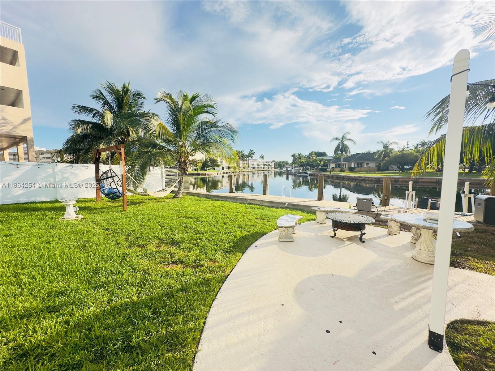 455 Golden Isles Drive, Unit 210 Hallandale Beach, FL 33009 - Photo 23 of 27 a view of a swimming pool and lounge chair