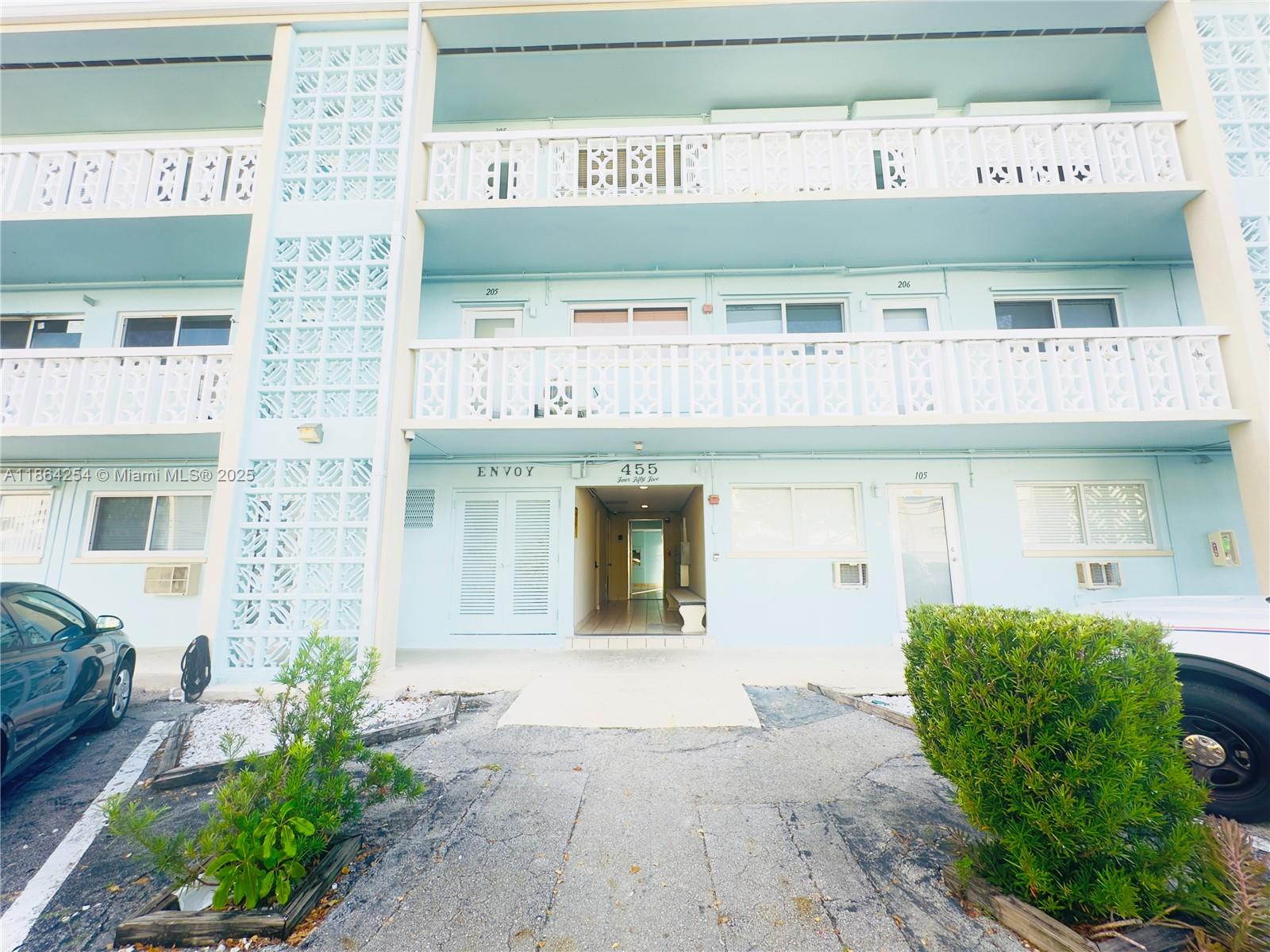 455 Golden Isles Drive, Unit 210 Hallandale Beach, FL 33009 - Photo 24 of 27 a view of a building with potted plants