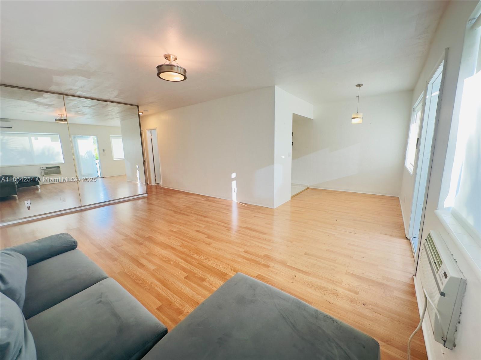 455 Golden Isles Drive, Unit 210 Hallandale Beach, FL 33009 - Photo 4 of 27 a view of livingroom with furniture and wooden floor