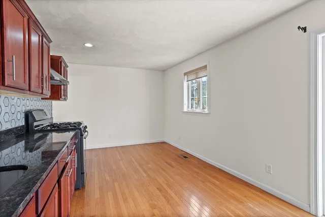 a view of a kitchen with wooden floor and a sink