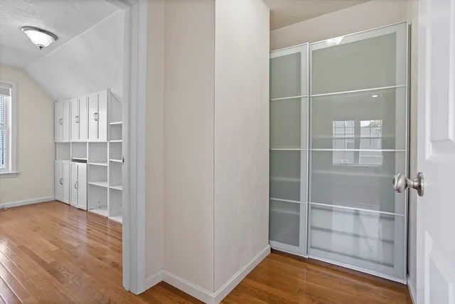 a view of empty room with wooden floor