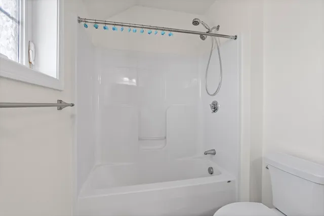 a bathroom with a shower and a toilet