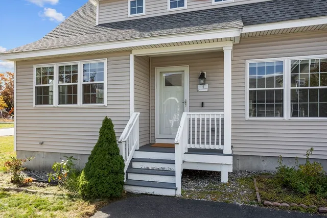 a view of a house with a small window and potted plants