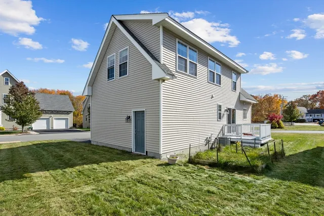 a backyard of a house with plants and outdoor seating
