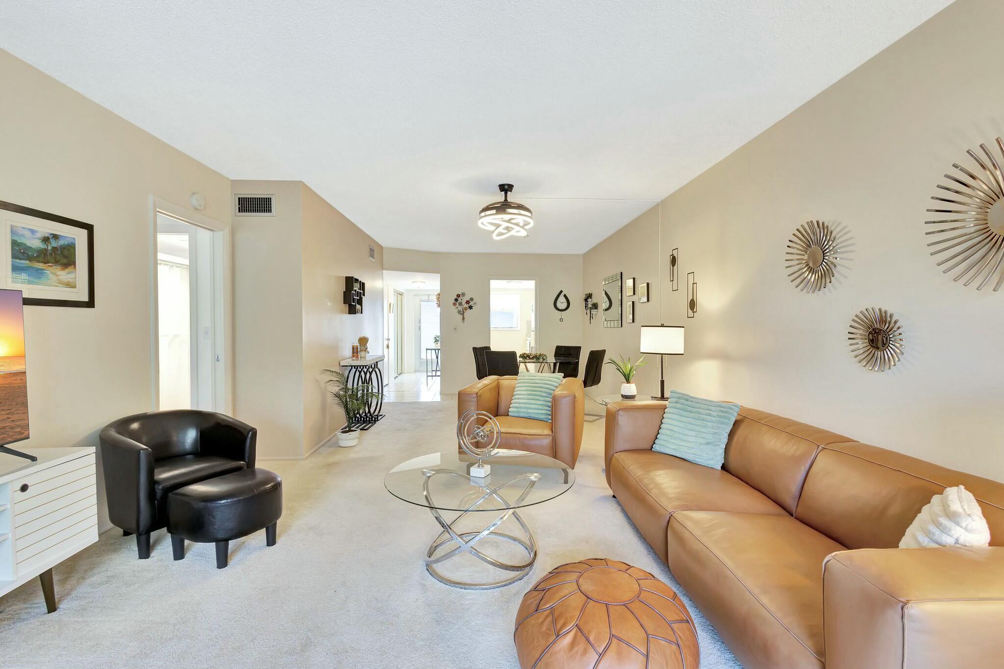 2320 Southwest 22nd Avenue, Unit 211 Delray Beach, FL 33445 - Photo 14 of 38 a living room with furniture and a window
