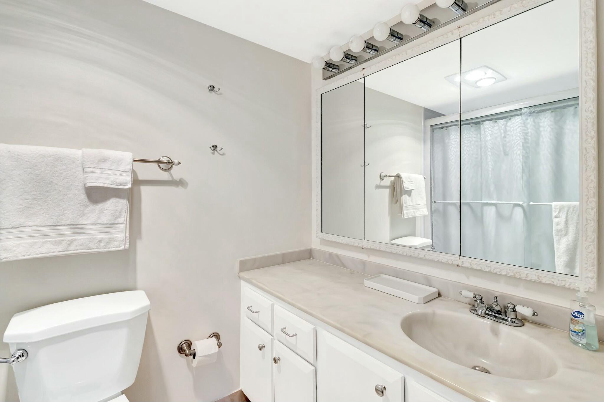 2320 Southwest 22nd Avenue, Unit 211 Delray Beach, FL 33445 - Photo 16 of 38 a bathroom with a sink toilet and shower