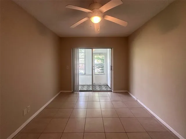 an empty room with closet and windows