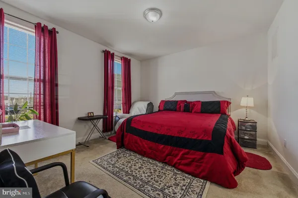 a bedroom with a bed couch and window