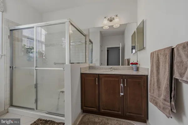 a spacious bathroom with a tub sink and mirror