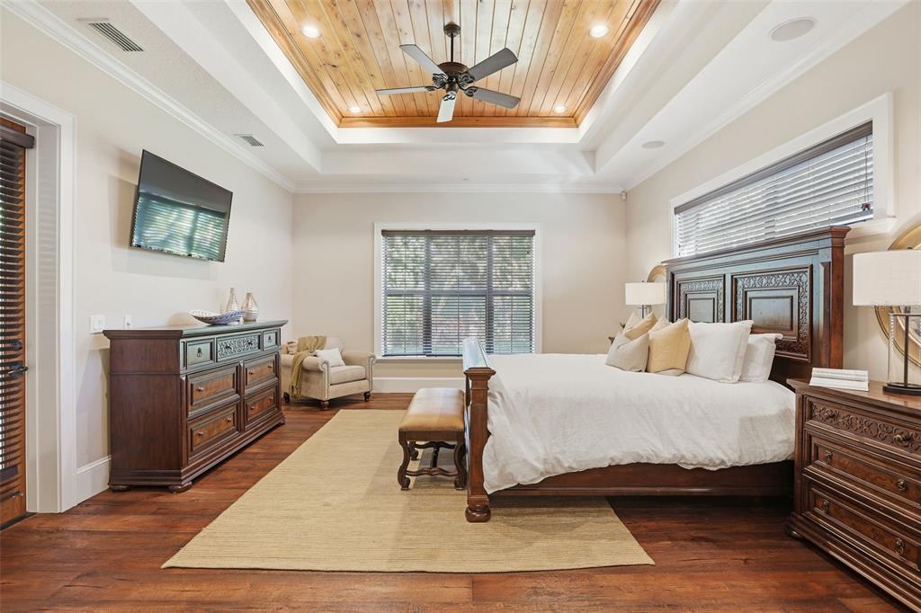 713 Main Street Windermere, FL 34786 - Photo 29 of 82 a bedroom with a bed a bookshelf and a window