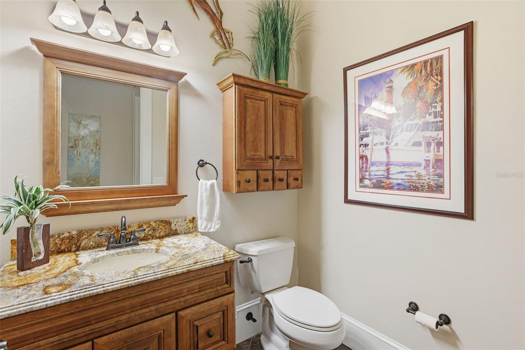 713 Main Street Windermere, FL 34786 - Photo 39 of 82 a bathroom with a granite countertop sink mirror vanity and toilet
