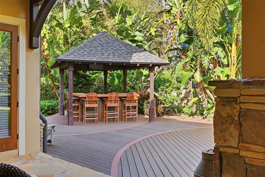713 Main Street Windermere, FL 34786 - Photo 65 of 82 a view of a patio with table and chairs under an umbrella with wooden floor
