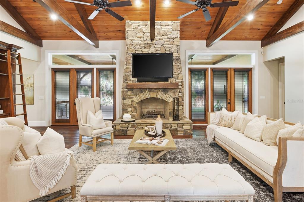 713 Main Street Windermere, FL 34786 - Photo 7 of 82 a living room with furniture a flat screen tv and a fireplace