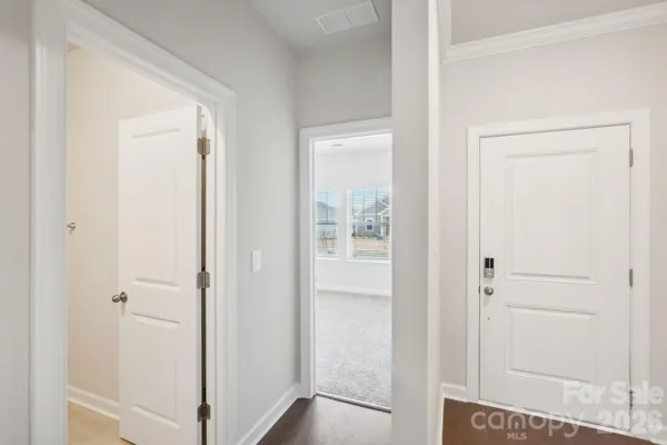a view of a room with white walls and cabinet