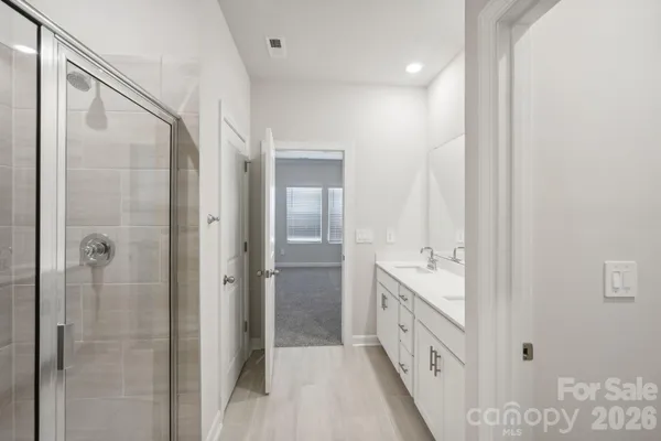 a bathroom with a sink double vanity and a mirror
