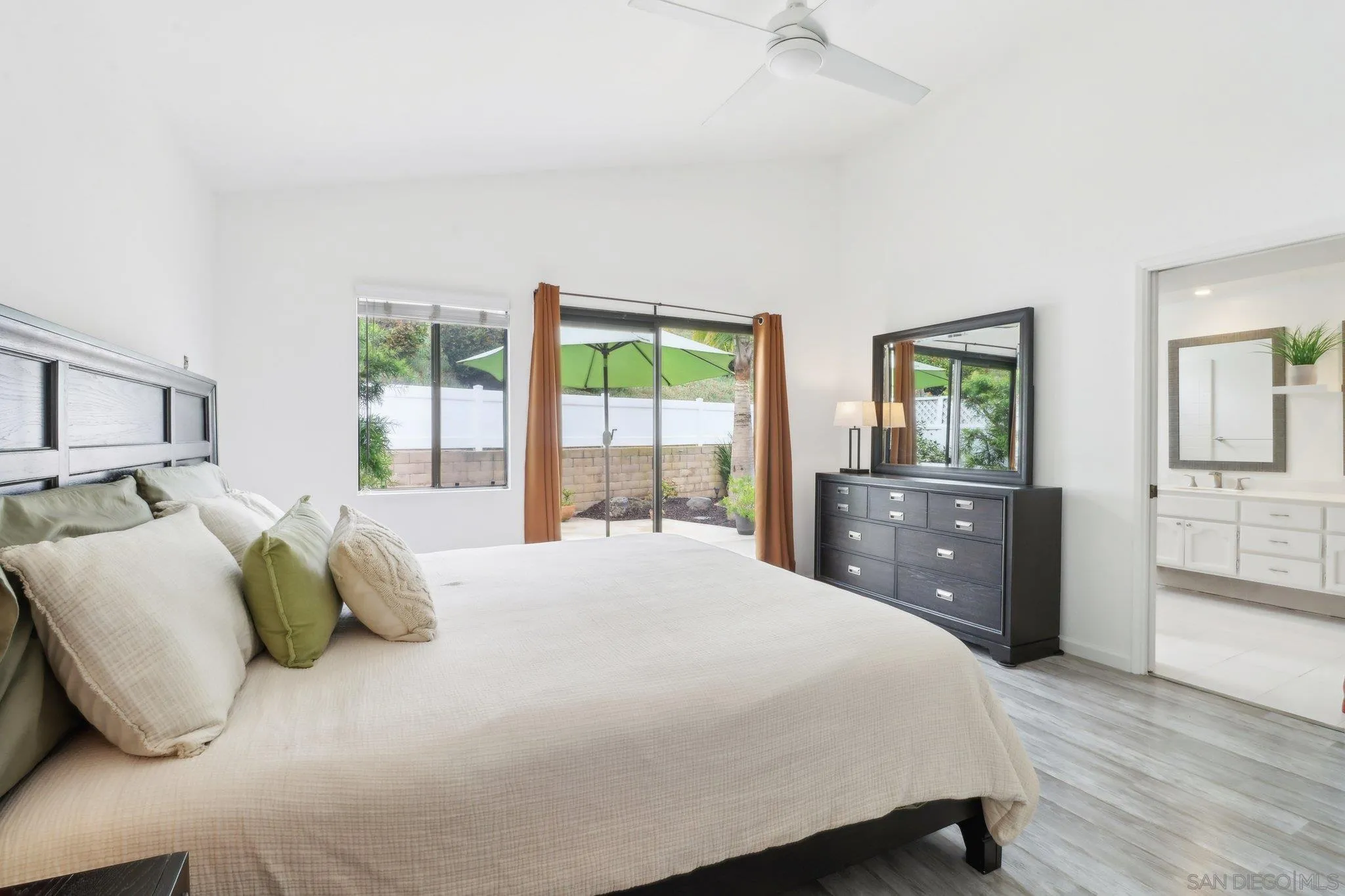 6872 Shearwaters Drive Carlsbad, CA 92011 - Photo 14 of 45 a bedroom with a bed and wooden floor
