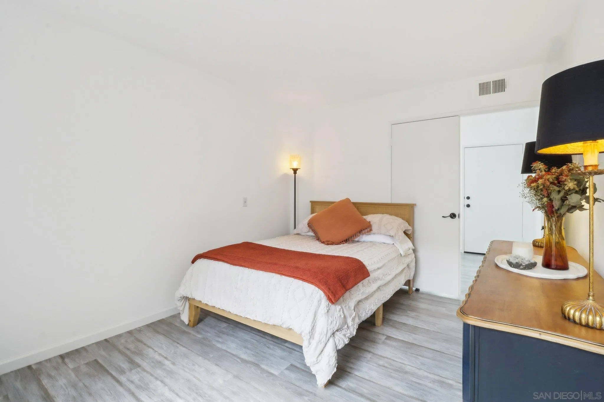 6872 Shearwaters Drive Carlsbad, CA 92011 - Photo 25 of 45 a bedroom with bed and a potted plant