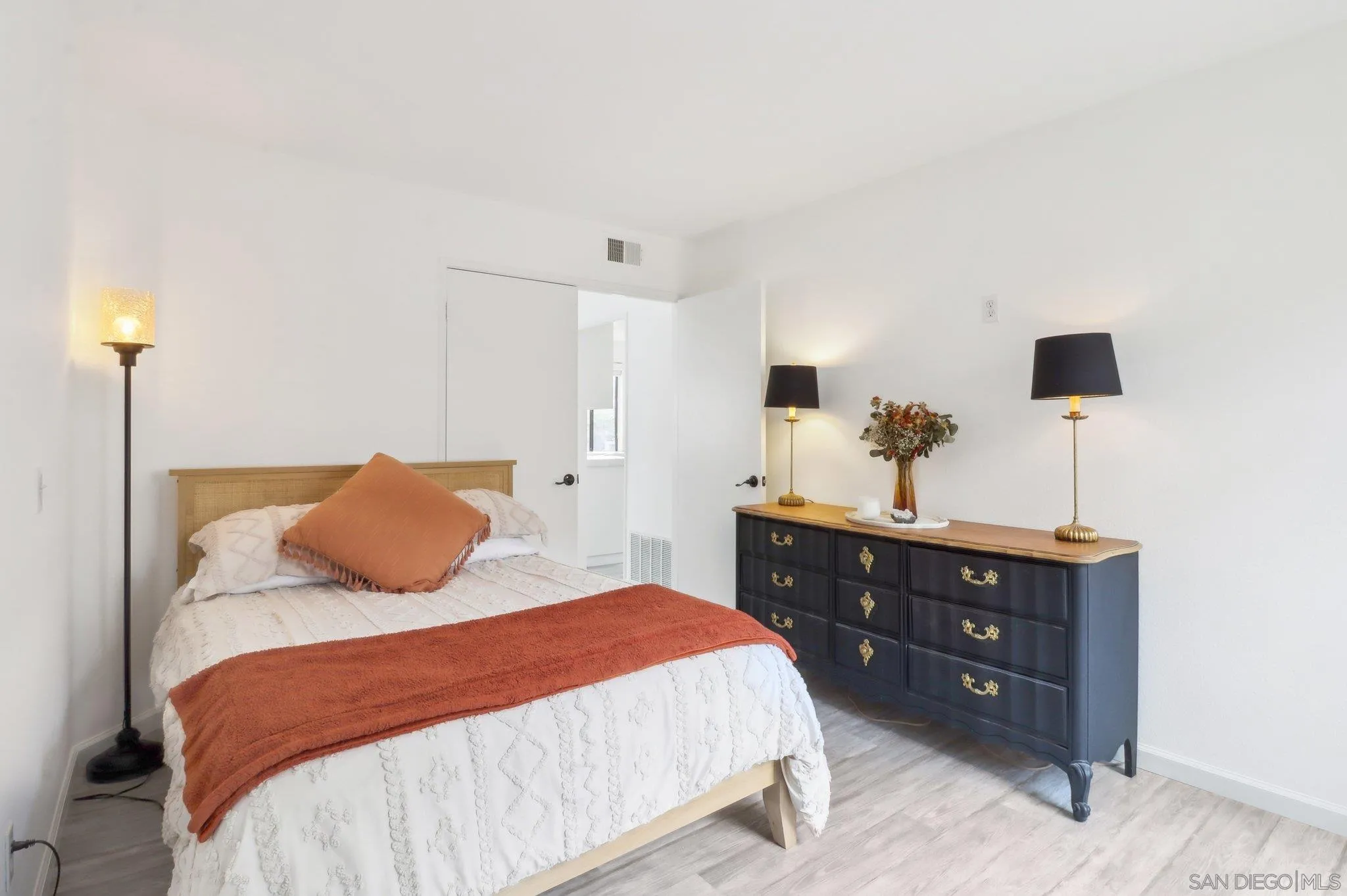 6872 Shearwaters Drive Carlsbad, CA 92011 - Photo 26 of 45 a bedroom with a bed and a night stand