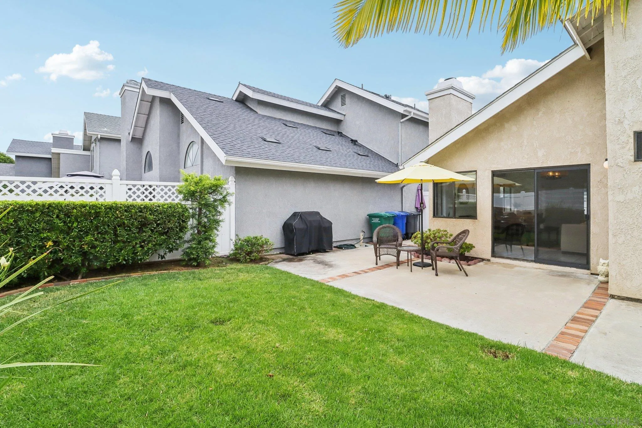 6872 Shearwaters Drive Carlsbad, CA 92011 - Photo 31 of 45 a view of a house with a patio and a yard