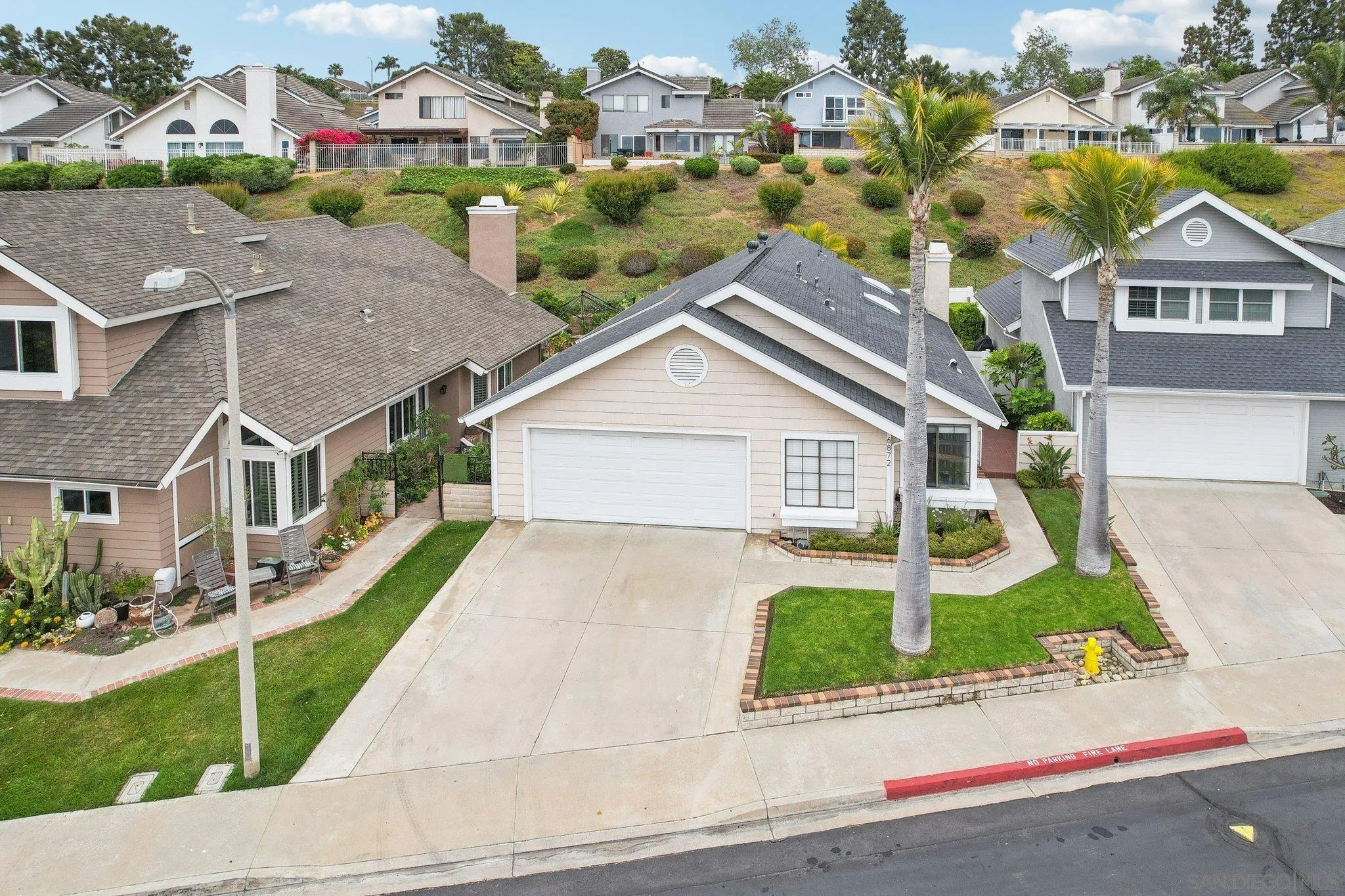 6872 Shearwaters Drive Carlsbad, CA 92011 - Photo 33 of 45 a front view of house with yard and green space